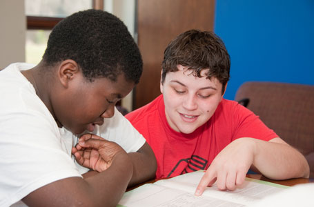 Boy helping another boy