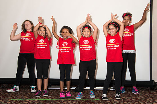 A group of young children show off their dance routine